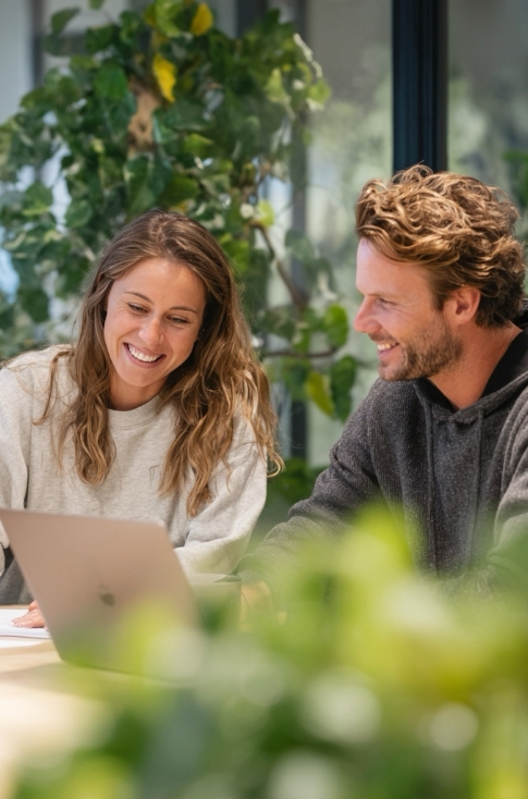 Couple smiling at a laptop